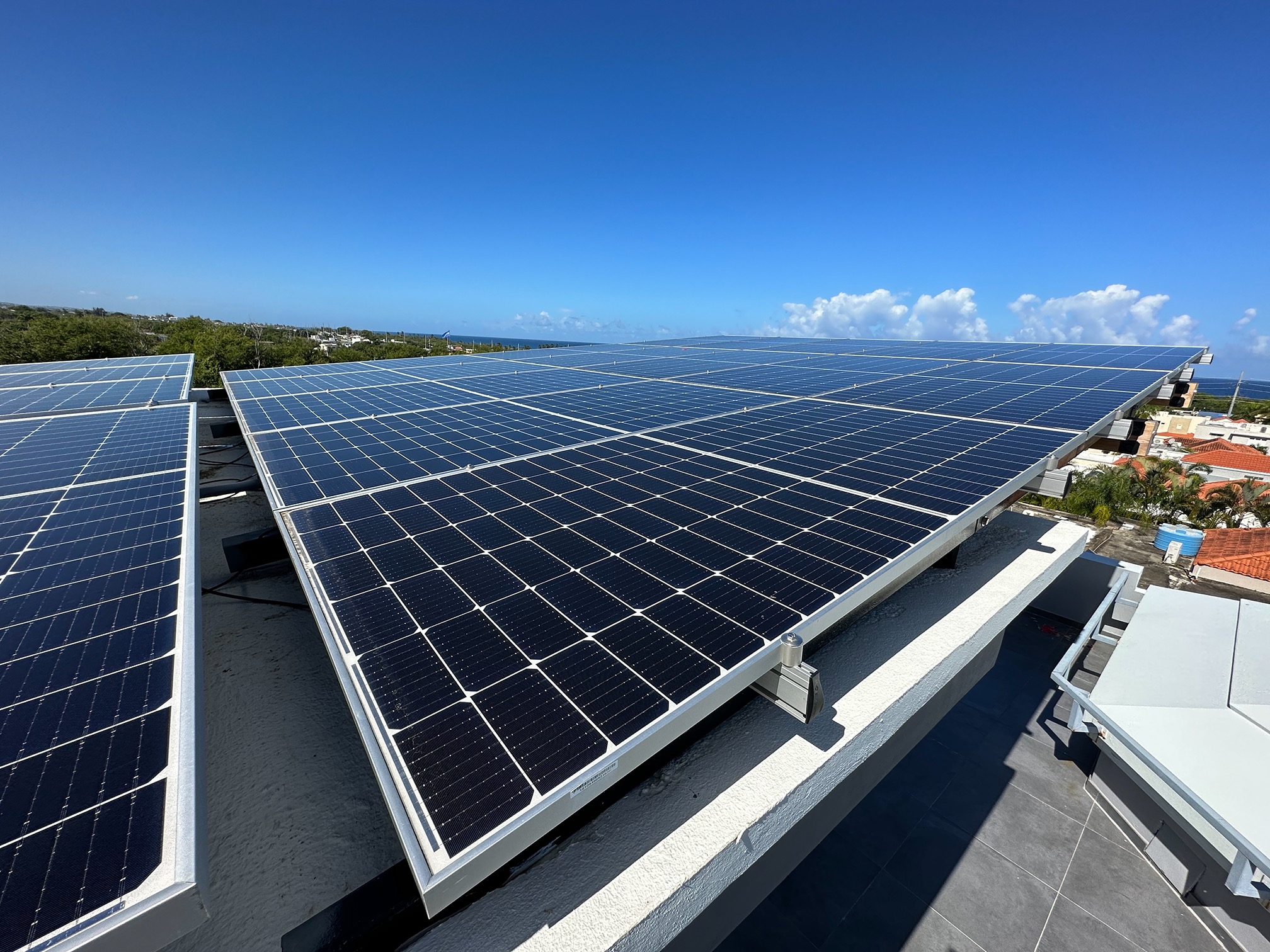 Aerial view of a rooftop solar array on a modern Puerto Rico home